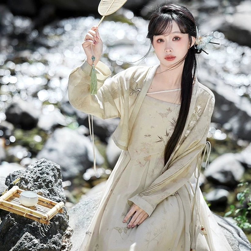 Seated view of Flower Paper Tang Dynasty inspired Hanfu set with ink style botanical print and sleeve tassel detail