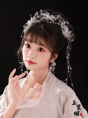 Three-quarter view of Flower Tears Chinese hanfu hair ornaments with iridescent floral beads and flowing tassels styled with a white traditional Chinese outfit
