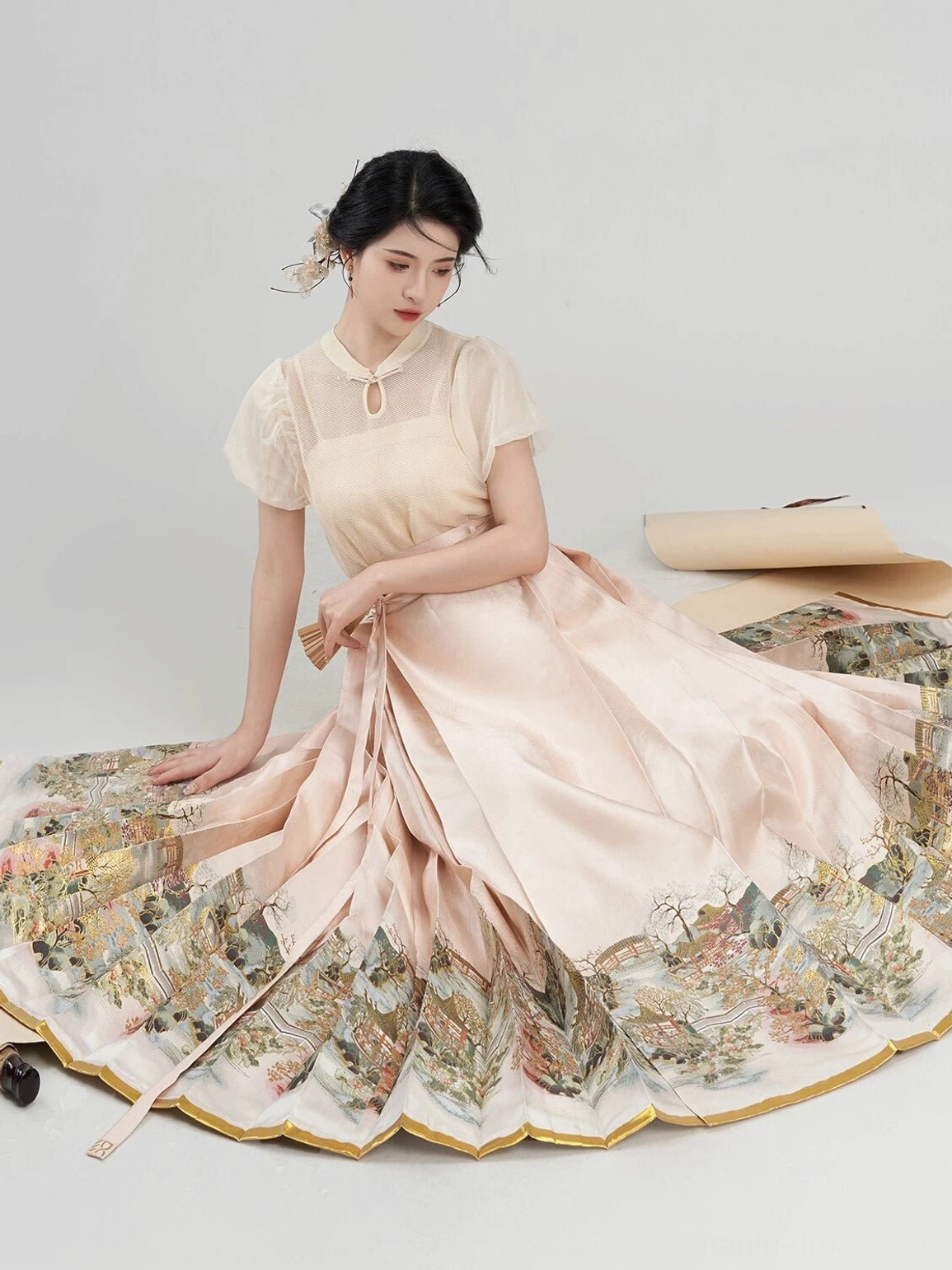 Low angle view of a flowing Ming inspired mamian horse-face skirt and matching Chinese blouse showing the full scenic landscape hem and gold trim