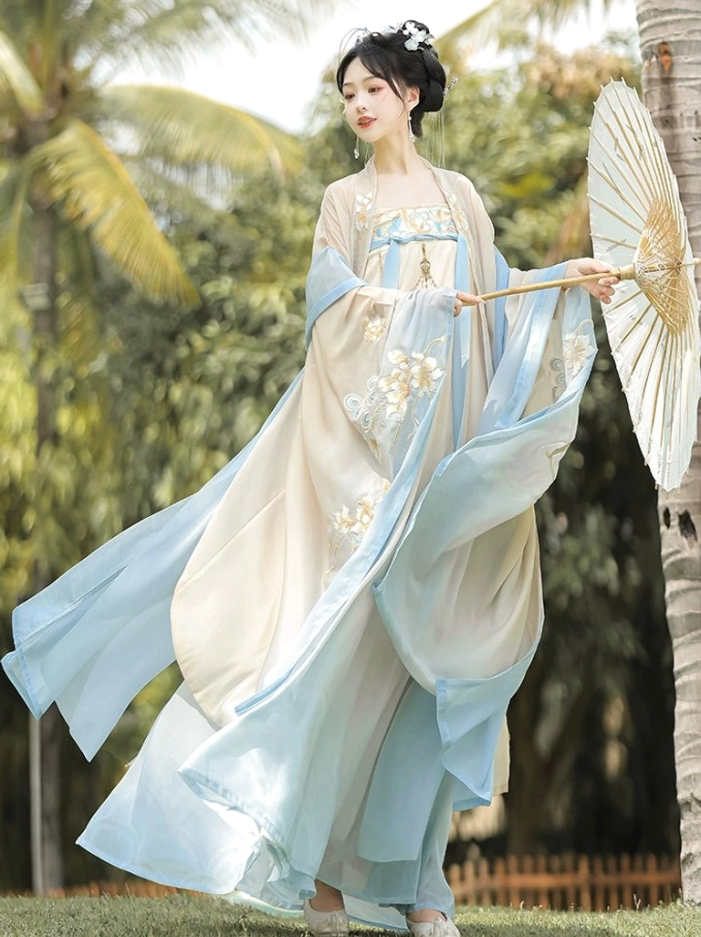 Flowing Tang Dynasty Hanfu Heziqun outfit with sky blue underlayers, wide chiffon drapery, delicate bodice embroidery, and graceful movement