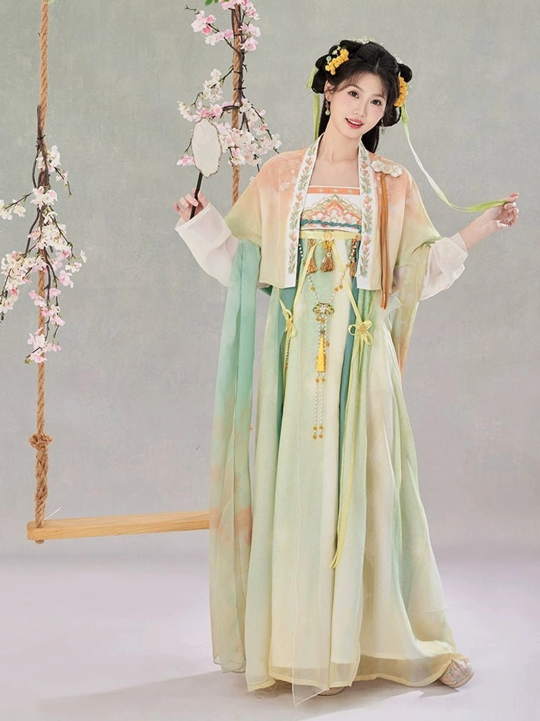Side three-quarter view of a flowing Tang Dynasty Hanfu Qixiong Ruqun dress with lightweight chiffon skirt, silk sash, green and yellow accents, and floral hair ornaments