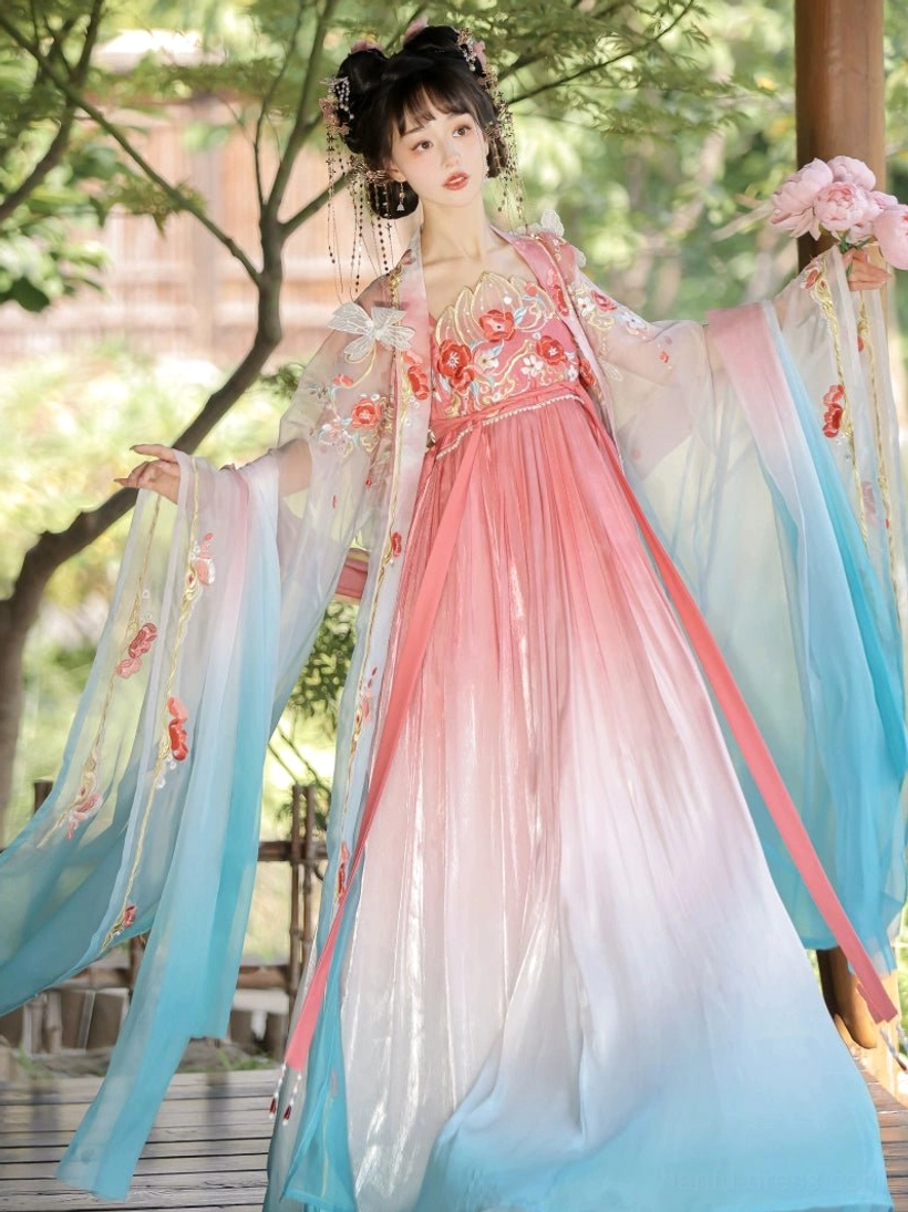 Flying Flower pink and cyan Tang Dynasty Hanfu dress with floral embroidered chest, wide sleeves, red waist sash, and flower accessory