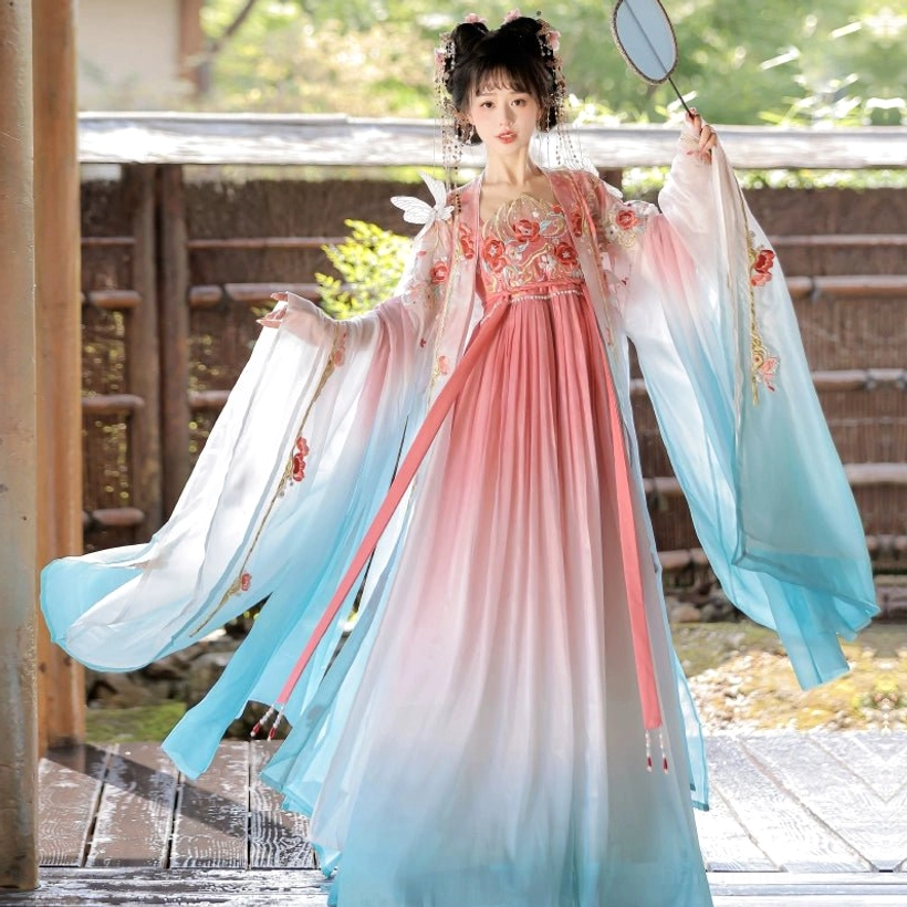Flying Flower Tang Dynasty Hanfu Heziqun dress with pink and cyan gradient fabric, floral embroidery, red long waist sash, and round silk fan