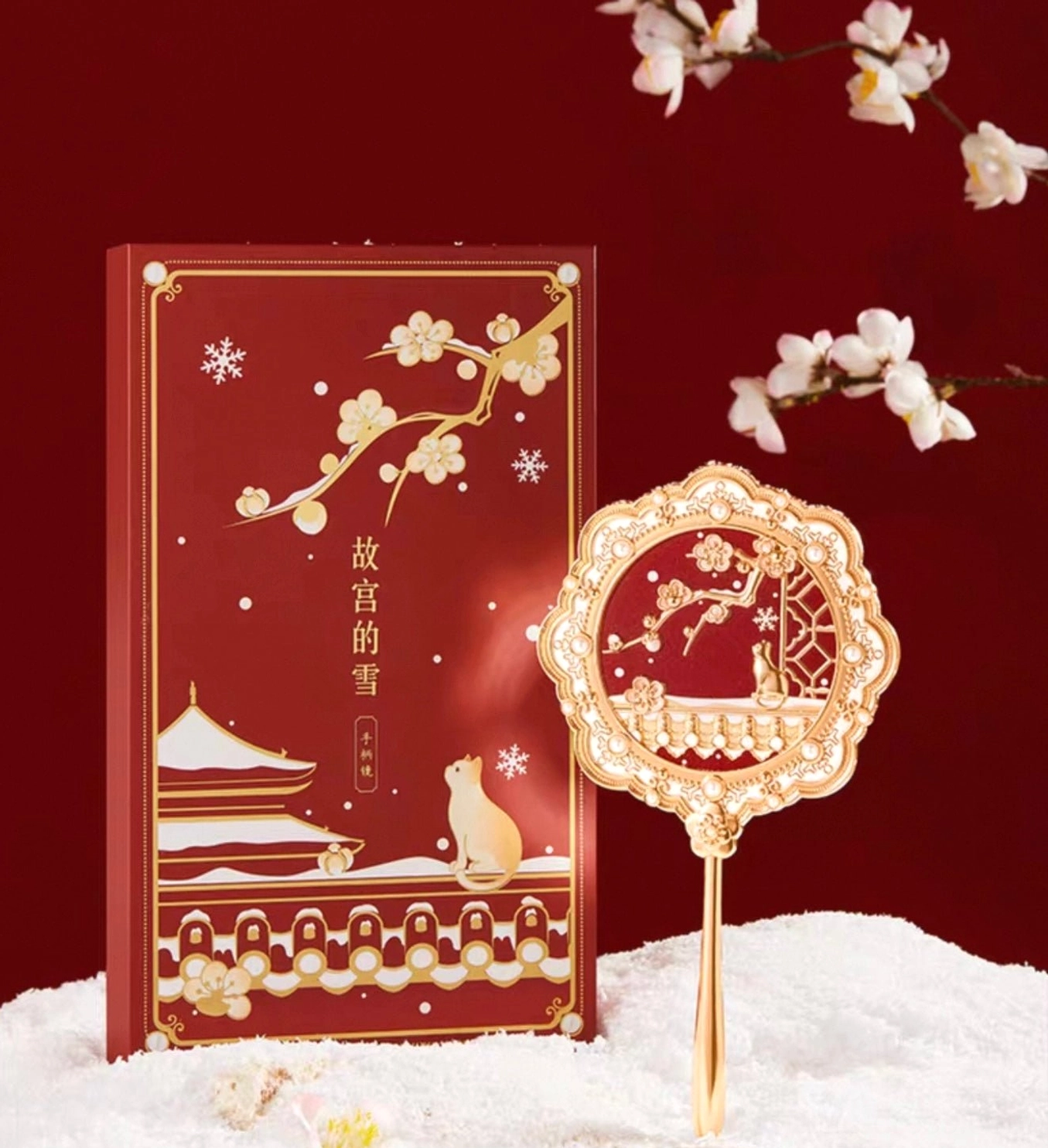 Forbidden City Snow plum blossom cat Chinese hand mirror with matching red oriental scenery gift box displayed on a snowy background