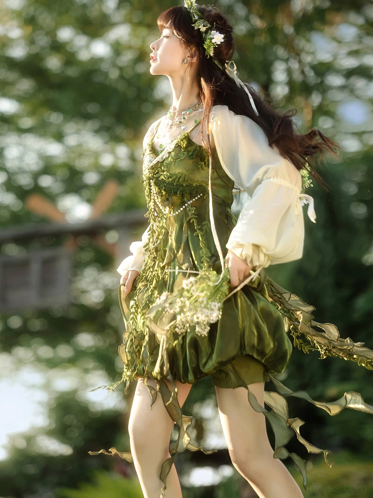 Side view of forest green Chinese style fairy dress and cardigan set with draped leaf frills flowing ribbons and woodland-inspired tassel hem