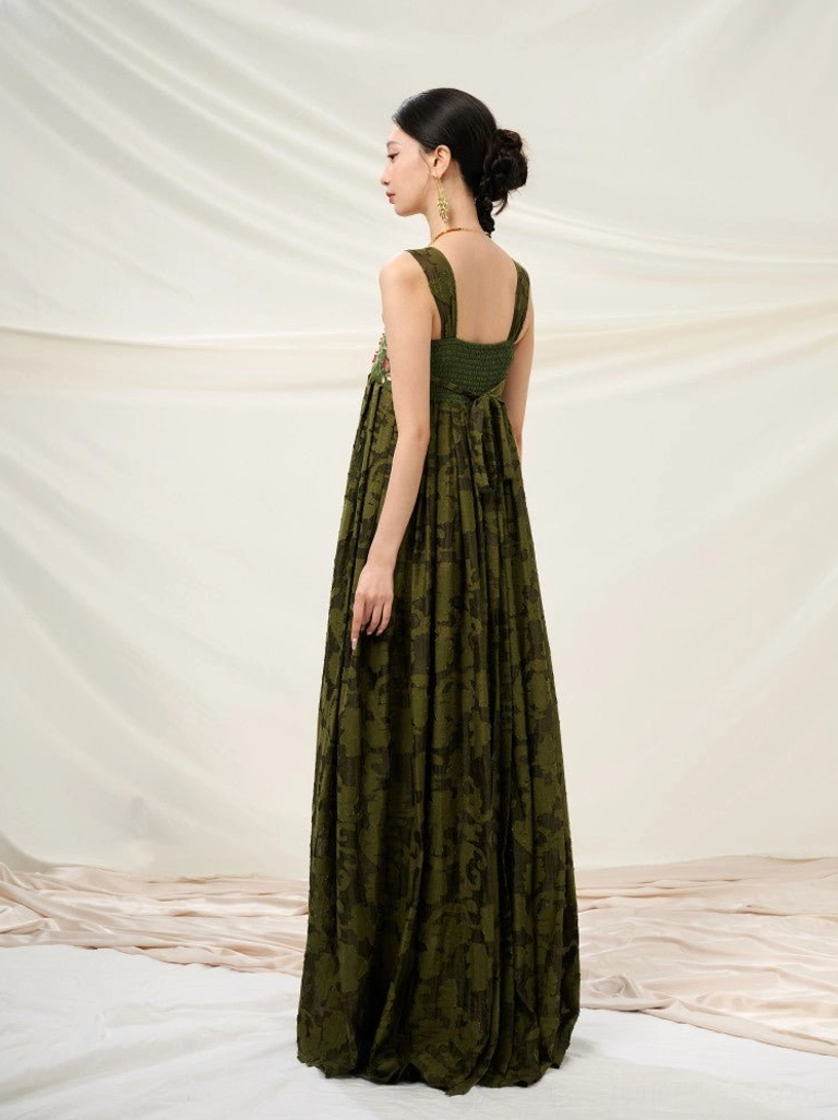 Back view of forest green embroidered modern Hanfu sundress showing wide shoulder straps smocked elastic back and long jacquard skirt