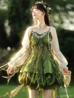 Front three quarter view of forest green Modern Hanfu fairy slip dress with jeweled bust trim leaf tassels and off white sheer lantern sleeve cardigan