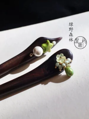 Forest Star Chinese hair stick for Hanfu hairstyle displayed on Chinese calligraphy paper with dark wood shaft green star charm and pearl pendant