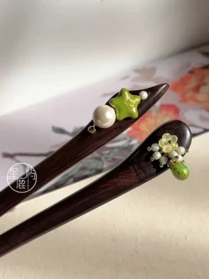 Traditional Chinese wooden hair sticks displayed against a flower and bird painting backdrop including Forest Star Hanfu hair accessory with green star and pearl
