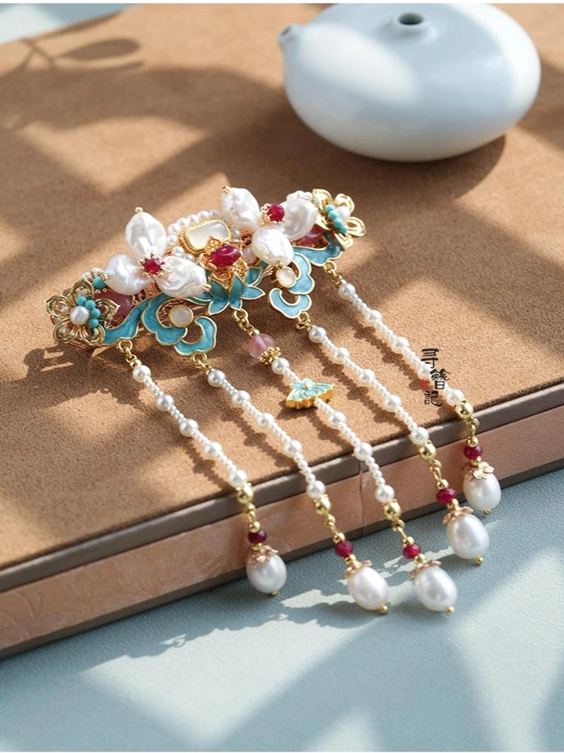 Blue gold and wine red Hanfu tassel hair clip with pearl strands floral metal motifs and teardrop pendants on wooden tea table