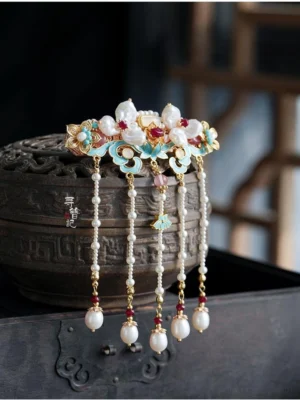 Vintage Chinese style Hanfu back hair pin with enamel flowers red stones and long layered pearl tassels displayed beside bronze incense burner