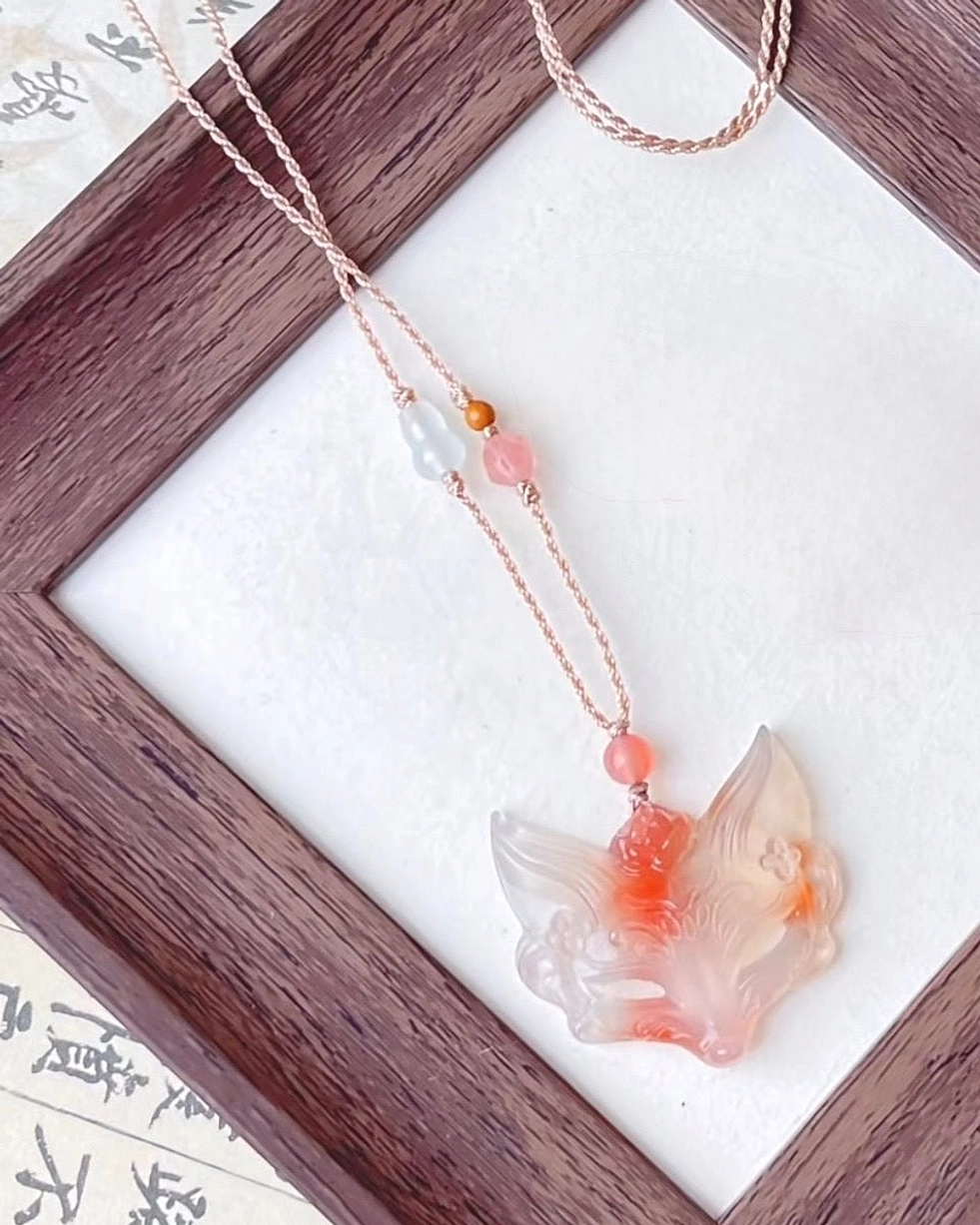 Handwoven rose gold toned cord Chinese necklace with translucent red and pink agate fox spirit pendant and matching agate beads
