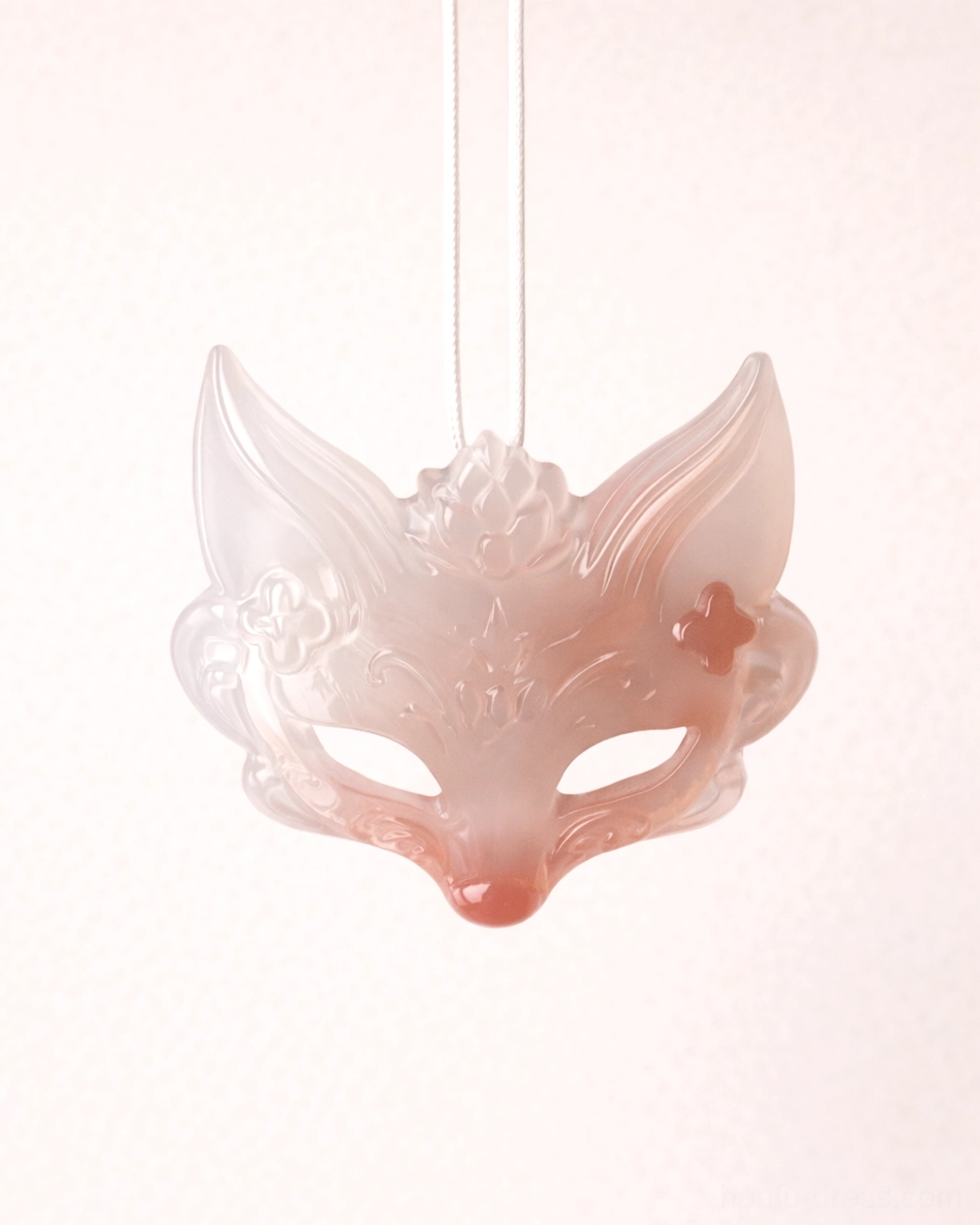 Close-up front view of translucent pink natural agate fox spirit mask pendant with delicate floral carving for handmade Chinese necklace