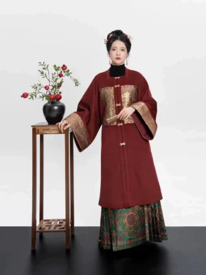 Front view of traditional Chinese Ming Dynasty Hanfu costume with red coat, frog buttons, wide sleeves, and green woven mamian skirt
