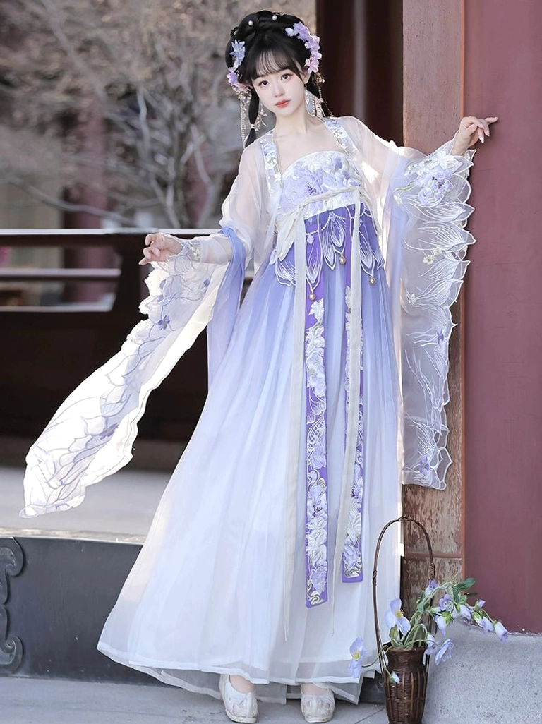 Front three-quarter view of a purple and white Tang Dynasty Heziqun Hanfu dress with vertical floral embroidery, ruffled sheer cuffs, and floor-length skirt
