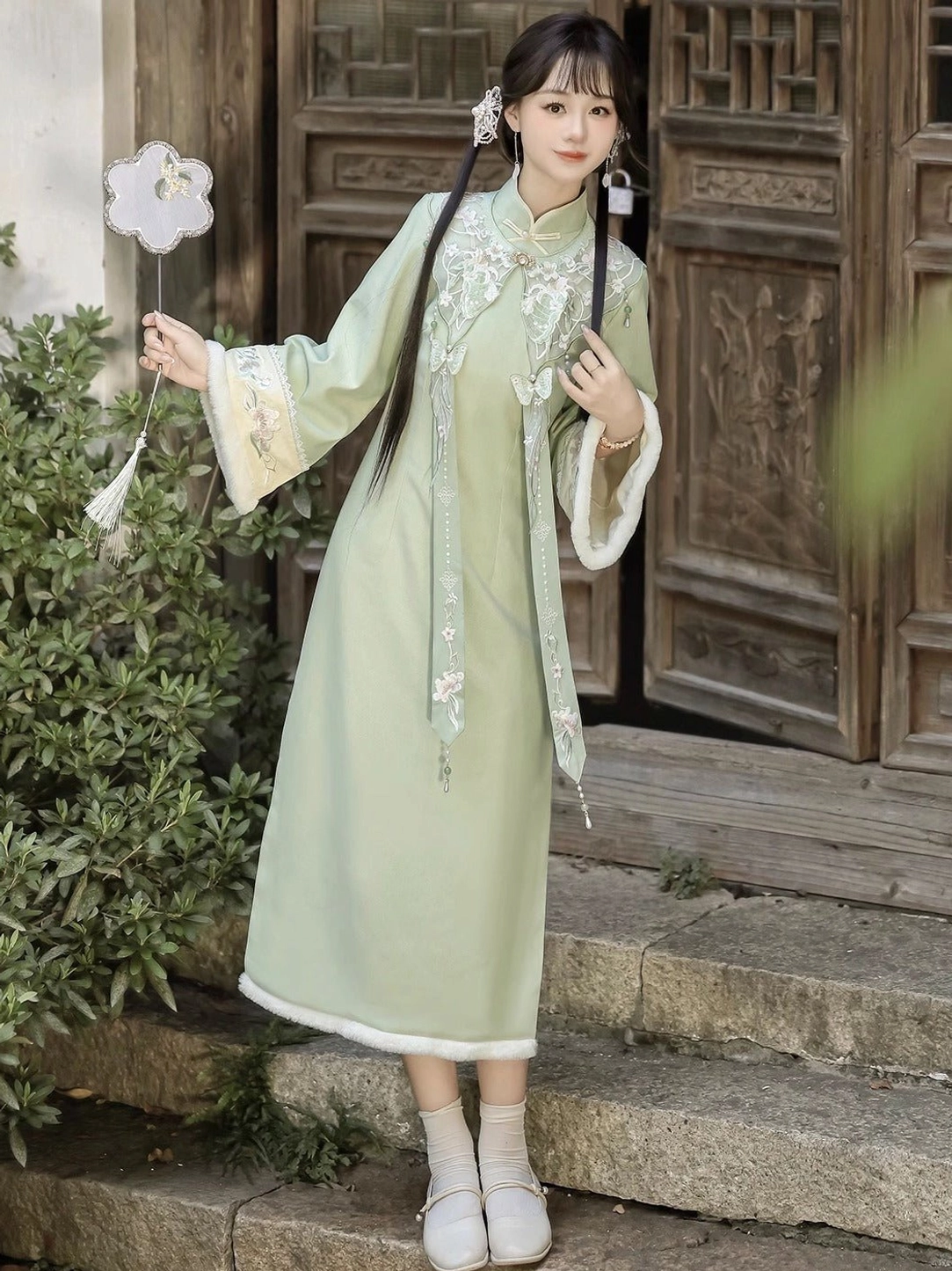 Front full-body view of Frost Butterfly light green modern Hanfu cheongsam dress with embroidered cloud collar and tassel ornaments