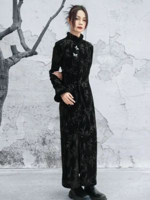 Full-length black bamboo jacquard velvet cheongsam dress shown from the side with fitted waist, floor-length hem, frog button collar details, and black boots