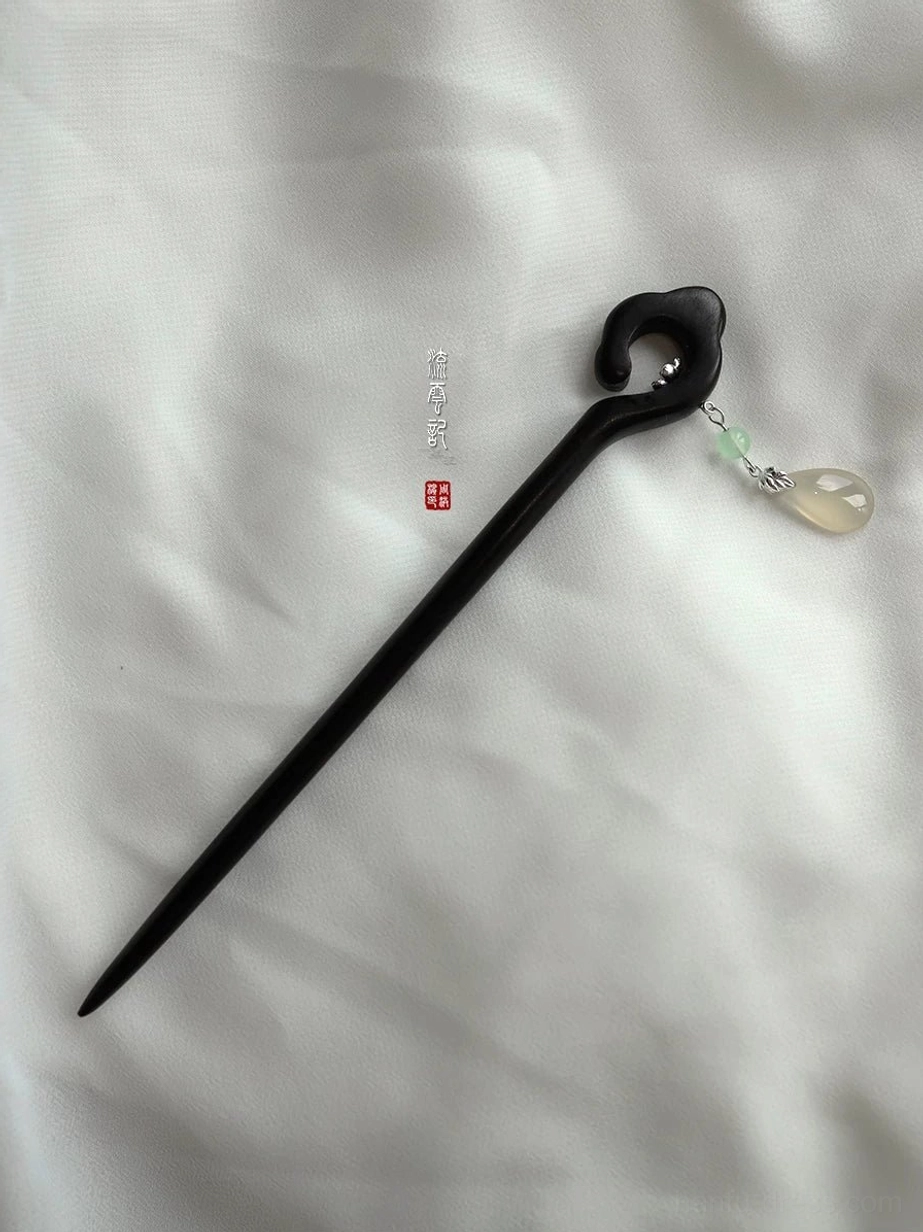 Full-length black wooden Chinese hairpin with cloud-shaped top, silver-tone flower accent, and green teardrop charm