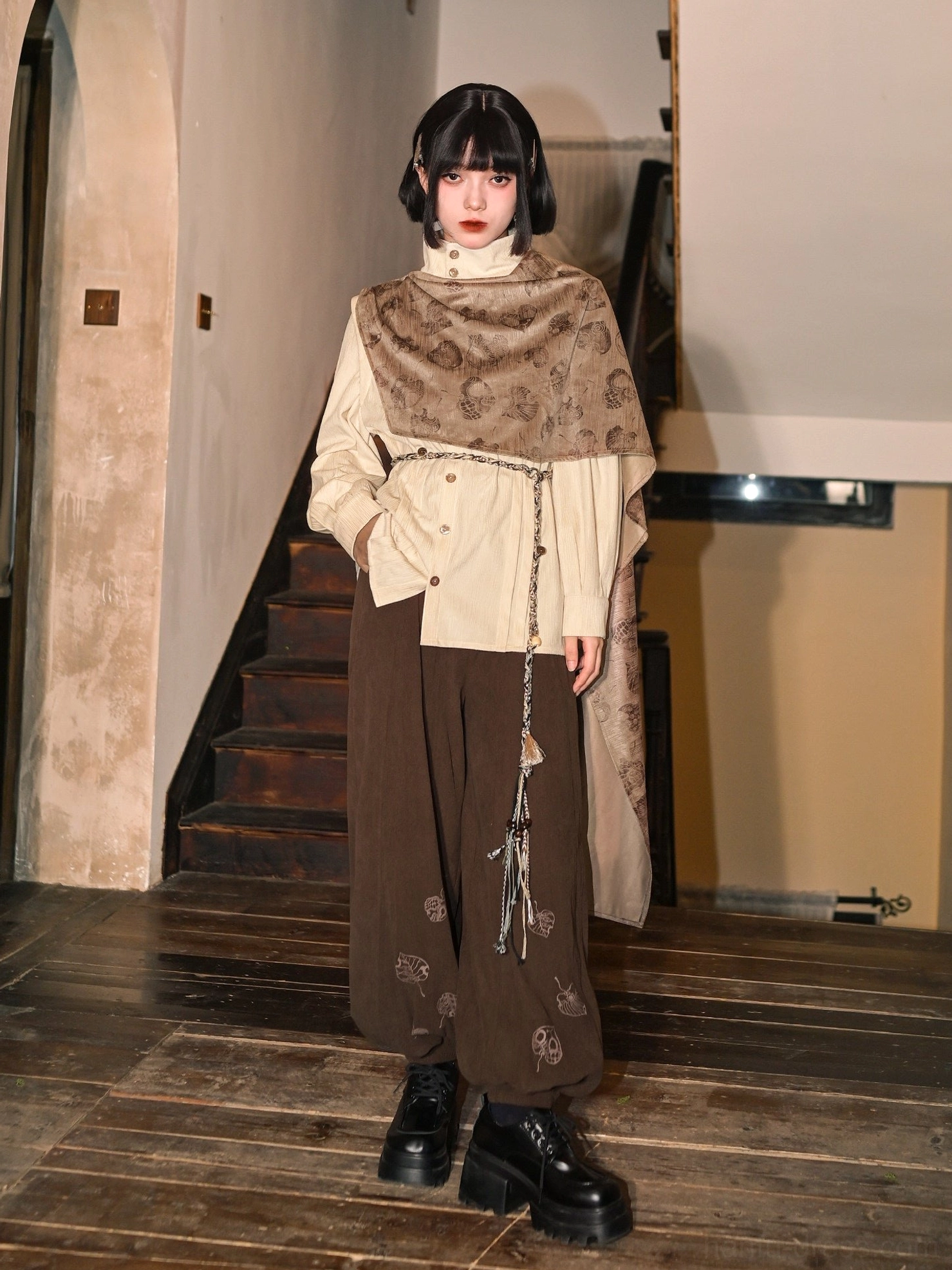 Full body vintage modern Hanfu outfit featuring beige long sleeve top, matching printed cape, dark trousers, tassel waist chain, and black platform leather boots