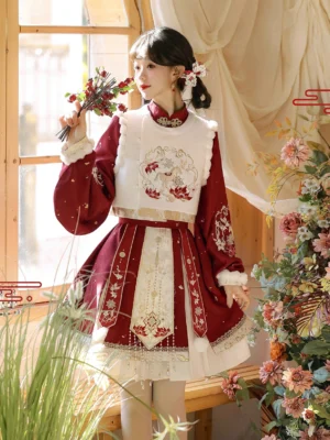 Side view of wine red and ivory Ming inspired Hanfu Chinese New Year outfit showing embroidered vest, auspicious motif and tassel skirt details