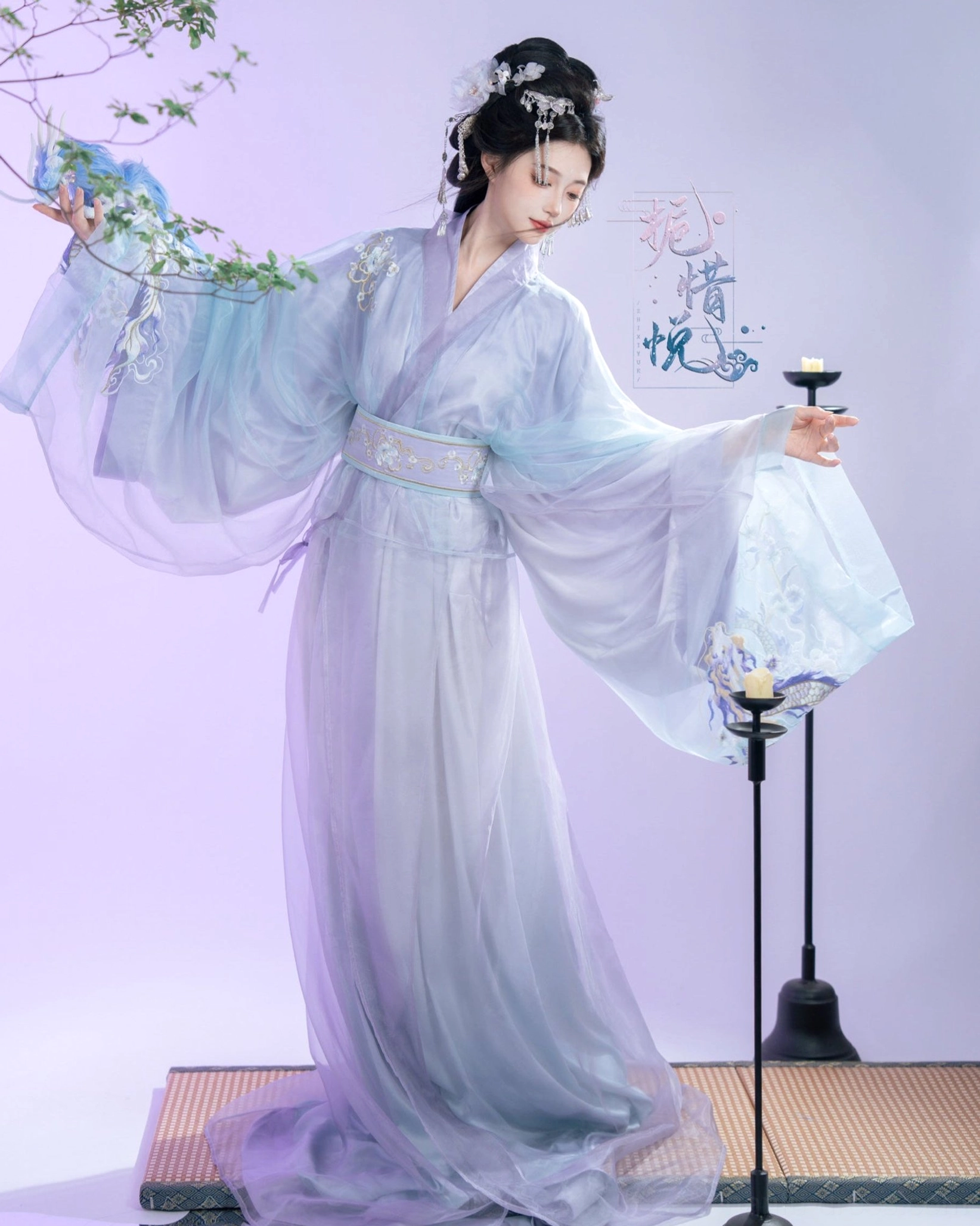 Gardenia Han Dynasty Hanfu straight hem robe set in blue and lavender, full body left three quarter view showing flowing wide sleeves and embroidered sash