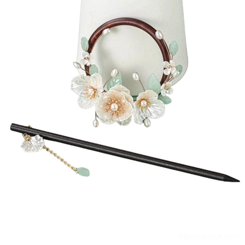 Minimal gardenia wood Chinese hairpin variation with small floral back ornament pearl detail and delicate tassel charm
