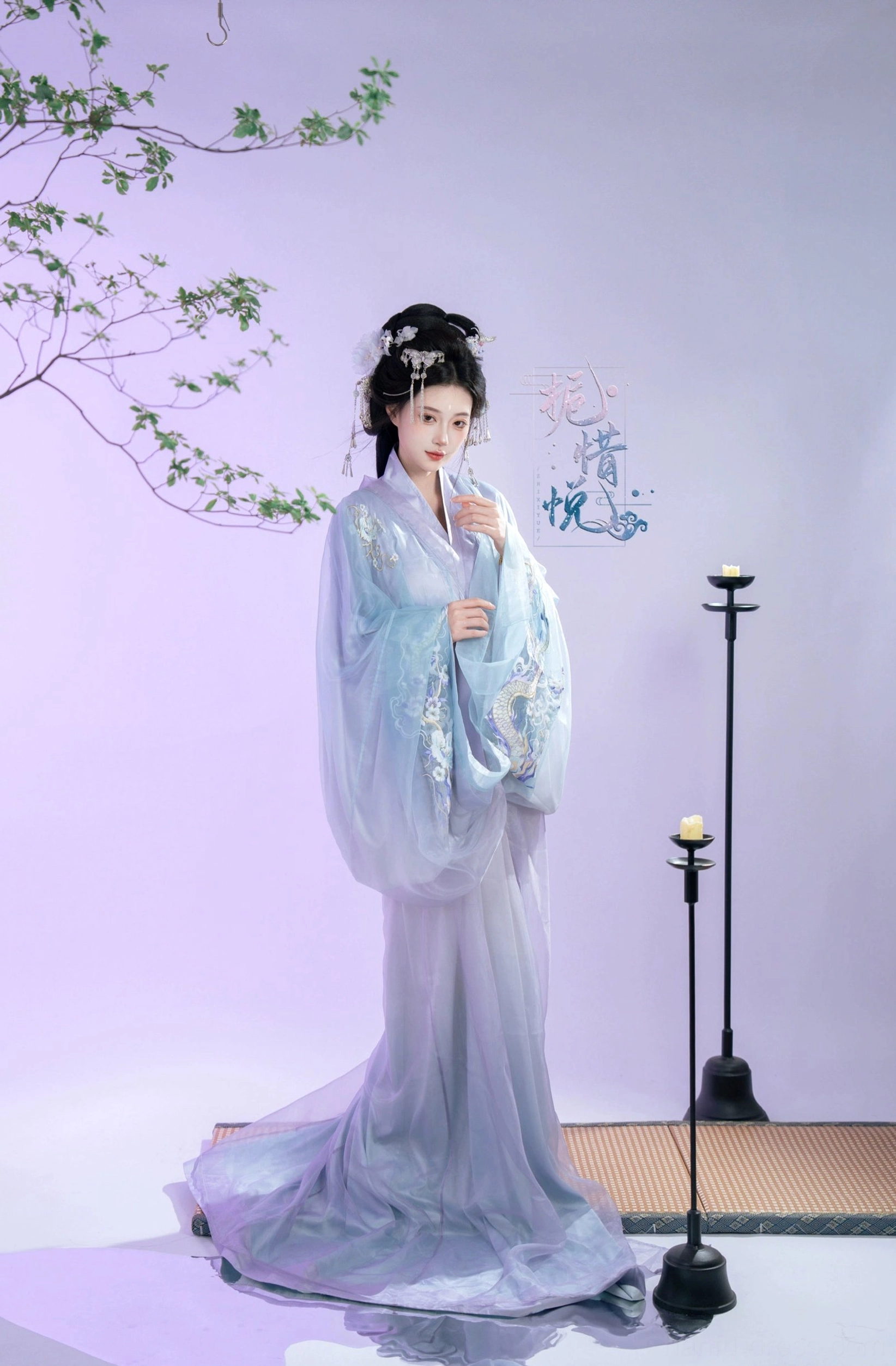 Gardenia XL train Han Dynasty Hanfu robe in blue and lavender, front three quarter view showing embroidered cross collar bodice, sash, and long trailing skirt