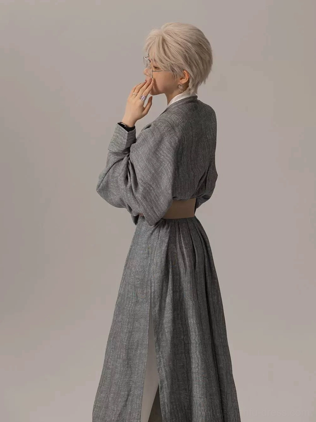 Side view of a gender neutral Tang Dynasty Hanfu robe with heather grey woven texture, oversized lantern sleeves, long side split, and tan leather look belt