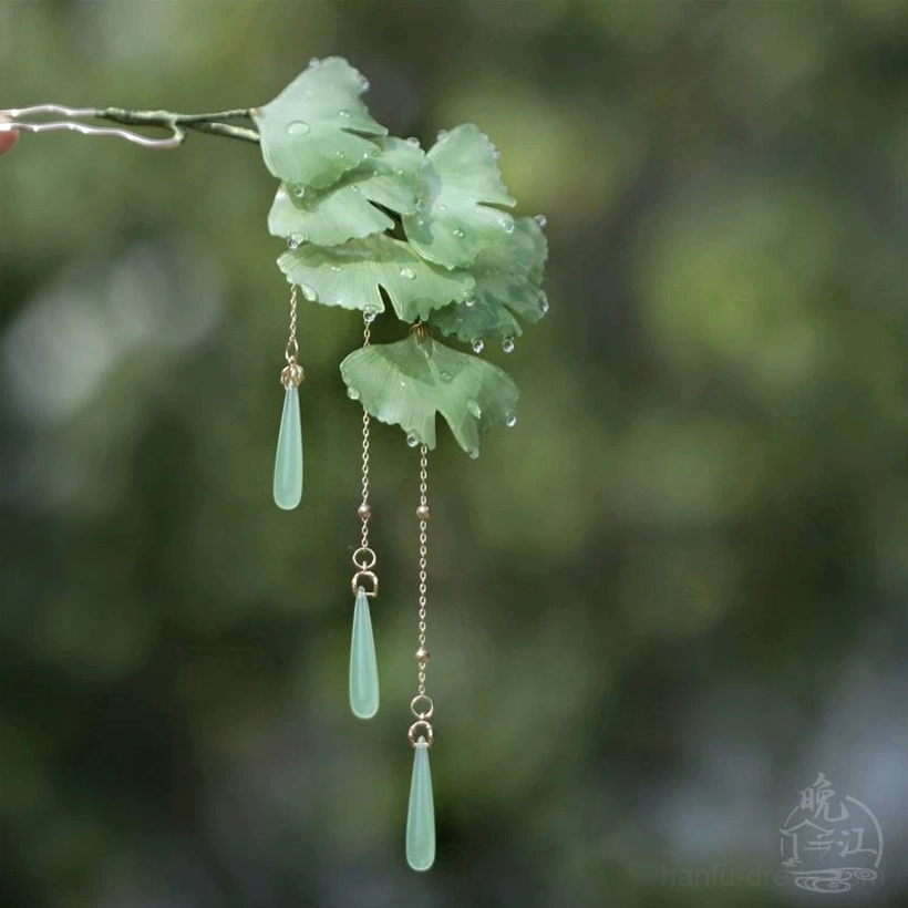 Side view of compact green ginkgo leaf hair stick with gold chains and jade-tone teardrop tassel ornaments