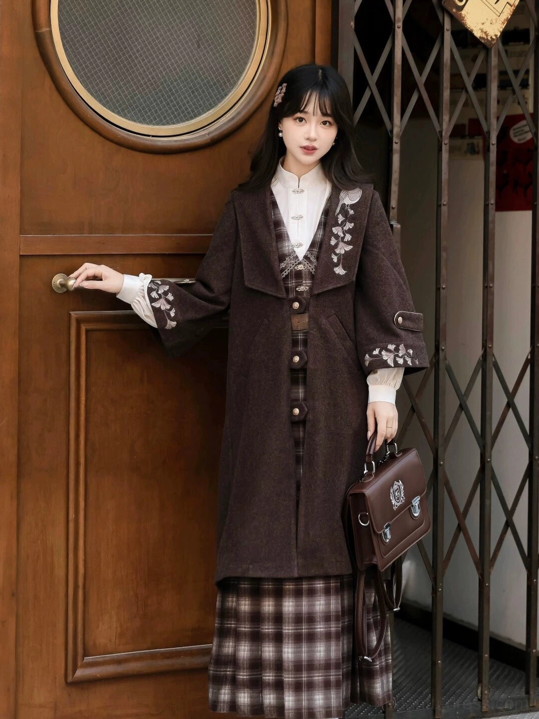 Side view of Ginkgo Notes modern Hanfu outfit showing floral embroidered brown coat and fitted plaid dress silhouette