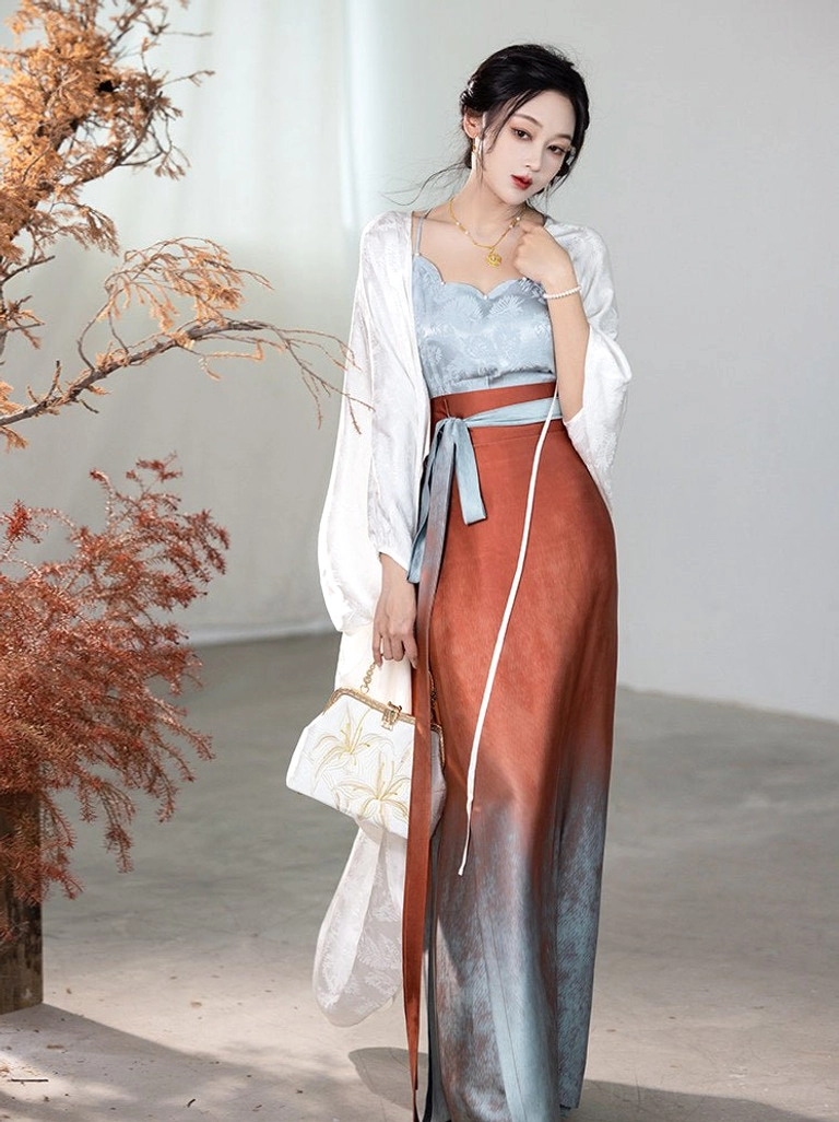 Glaze red Song Dynasty Hanfu outfit with ivory long cardigan, blue camisole, and gradient wrap skirt shown in three-quarter full-body studio view