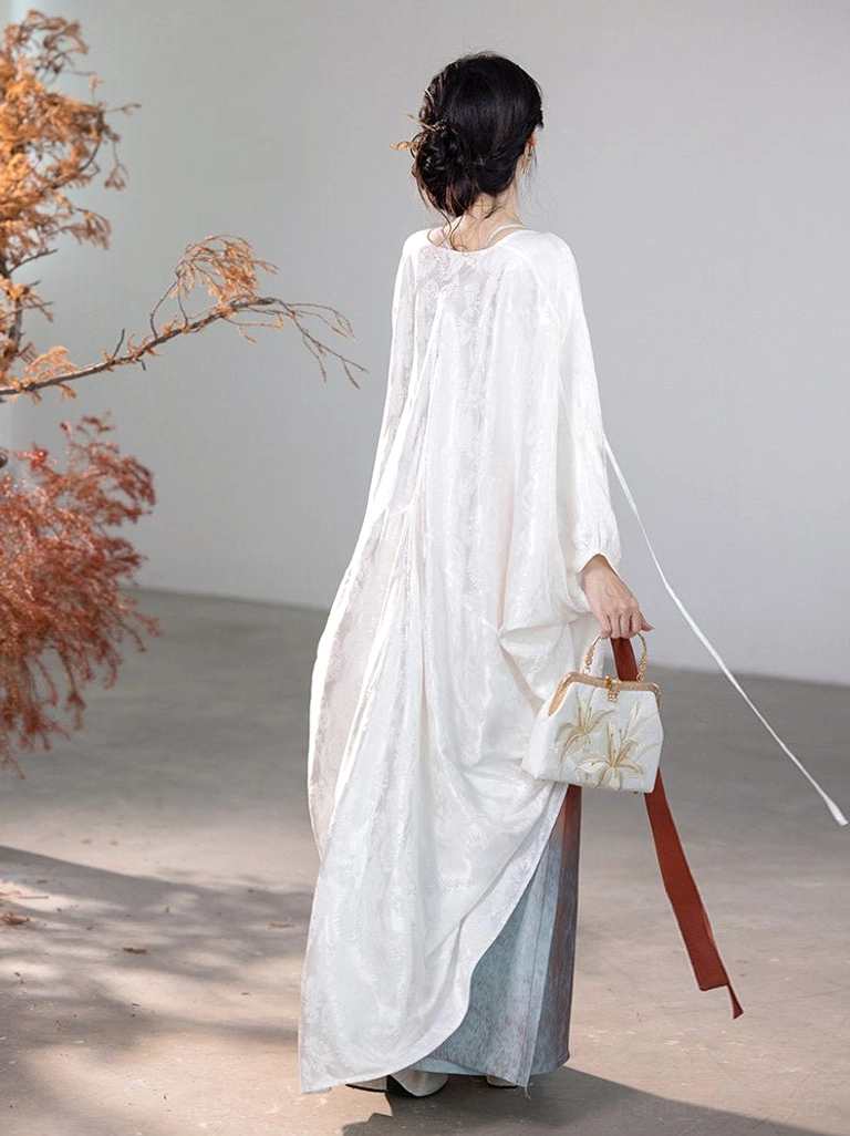 Back view of the Glaze Red Song Dynasty Hanfu showing the long flowing ivory cardigan and trailing dual-tone waist ties