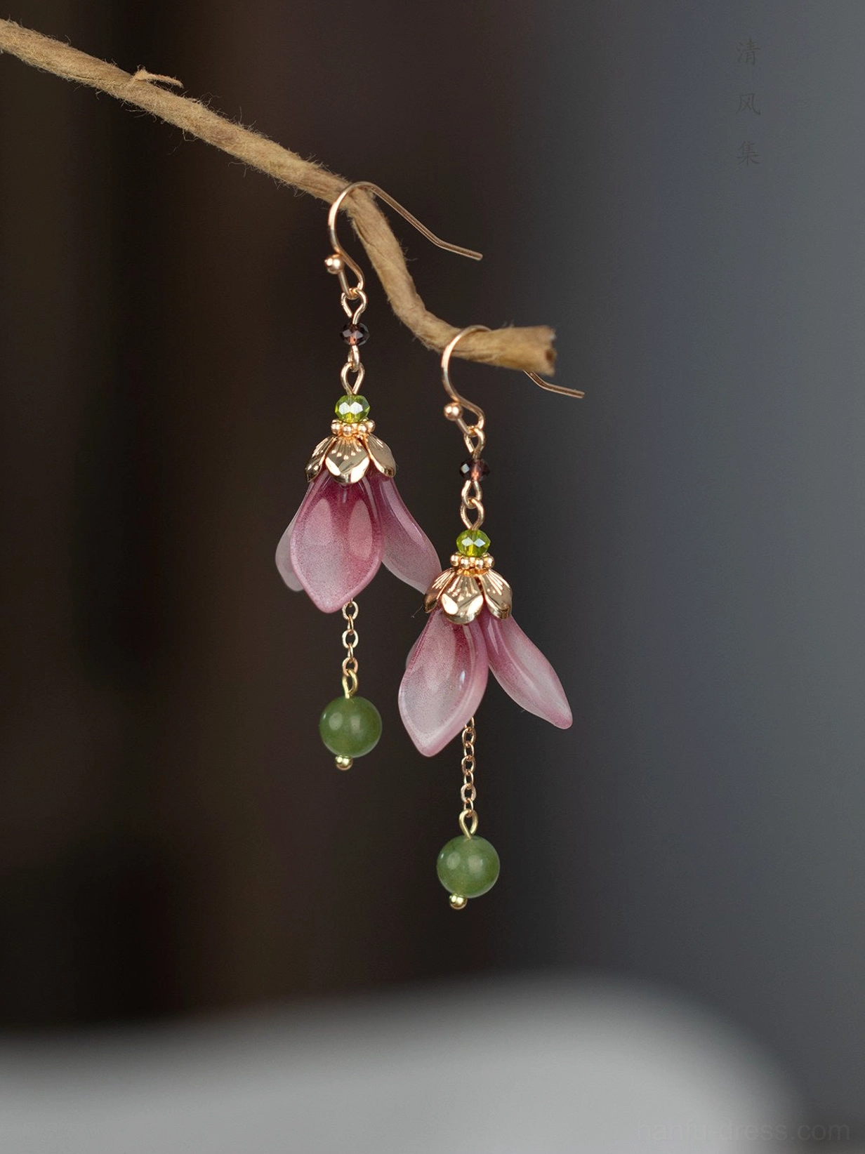 Close view of glazed flower bud Hanfu earrings with rose gold tone hooks, purple floral buds, delicate chains, and jade green bead drops