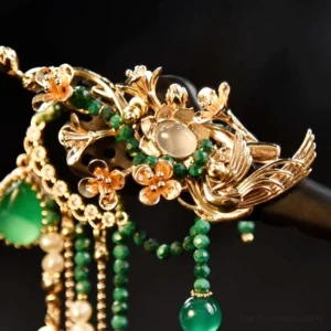 Close-up of Gliding Peacock Chinese hair stick crown with gold-tone bird and flower metalwork green agate white stone detail and tassels