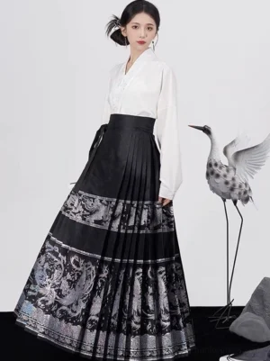 Full front view of black Ming Dynasty inspired Mamianqun horse face skirt with silver phoenix cloud brocade and white cross-collar Hanfu top