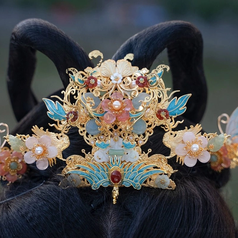 Back close-up of antique gold tone Hanfu hair crown with blue enamel leaves pink flowers and red gemstone accents