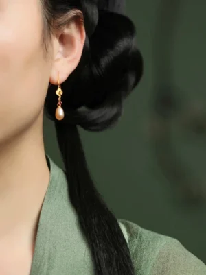 Golden cloud and pearl drop Chinese earrings worn with green Hanfu, showing elegant dangling 925 silver hook earring styling at the ear