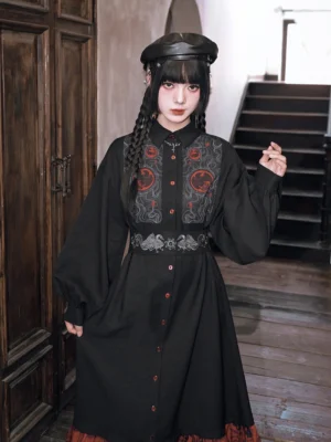Front view of the Golden Crow Chinese-inspired embroidered shirt dress showing chest embroidery, waist seal detail, lantern sleeves, and button-front design