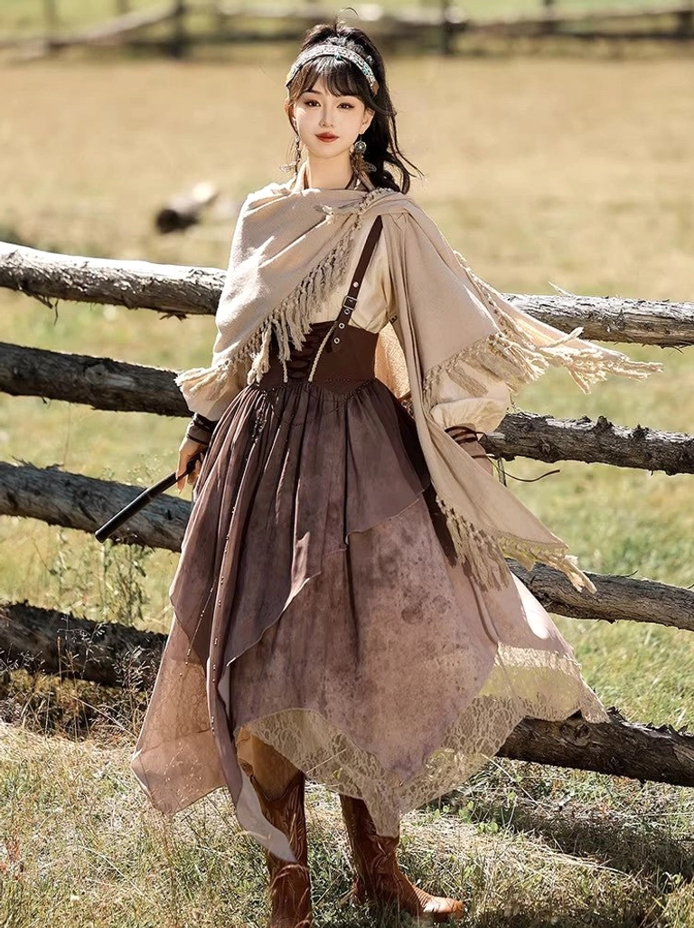 Front full-body view of a modern Chinese Hanfu set with brown puff-sleeve top, corset waist, irregular lace-trimmed suspender skirt, tasseled shawl, pearl headband, and brown boots in a pastoral grassland setting