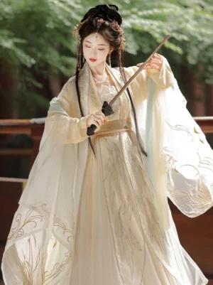 Front view of Golden Glow Song Dynasty inspired Qiyao Ruqun Hanfu showing cream yellow fabric, wide lapels, oversized sleeves, intricate golden embroidery, layered tops, and flowing wrap skirt