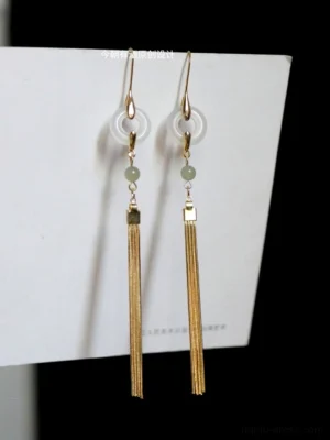 Front view of golden jade branch tassel Chinese earrings with pale green beads clear white ring pendants and long chain tassels for Hanfu