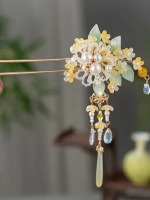 Front view of golden osmanthus floral Chinese hair stick with double prongs tassels pearl-look beads and green leaf details for Hanfu hairstyles