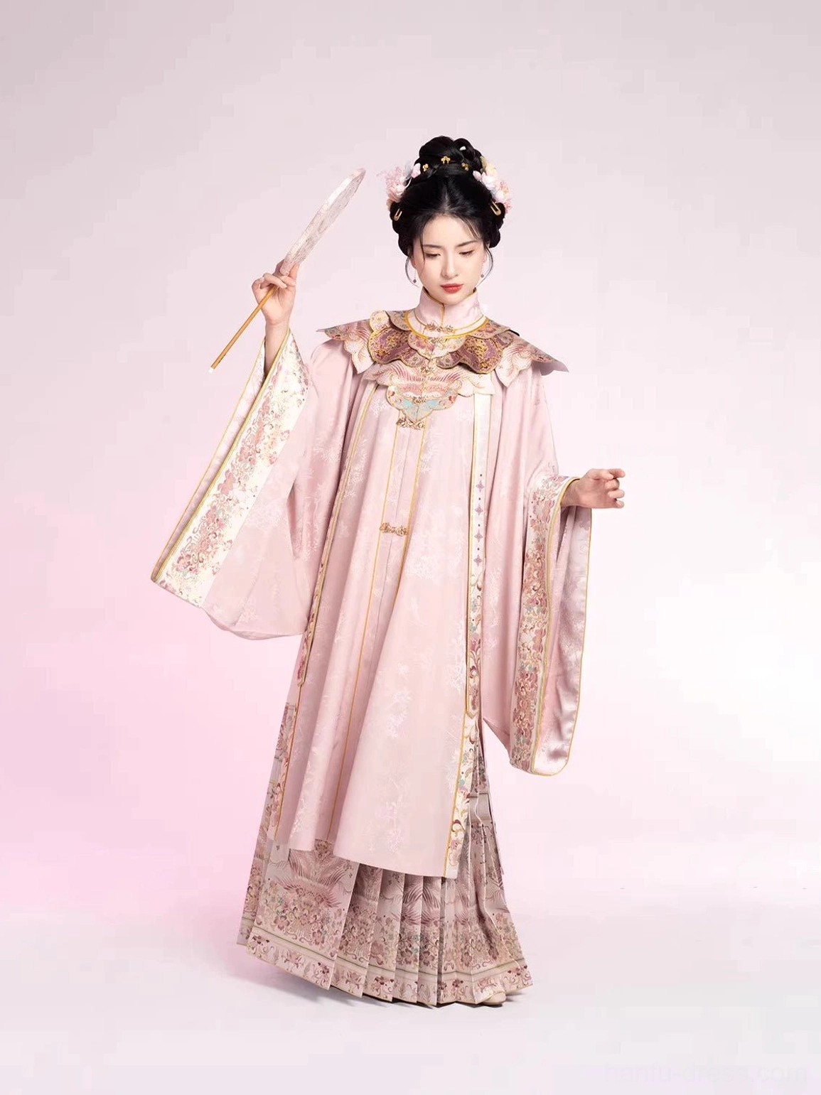 Ming Dynasty style dusty pink hanfu robe side profile with wide sleeves and embroidered golden trim