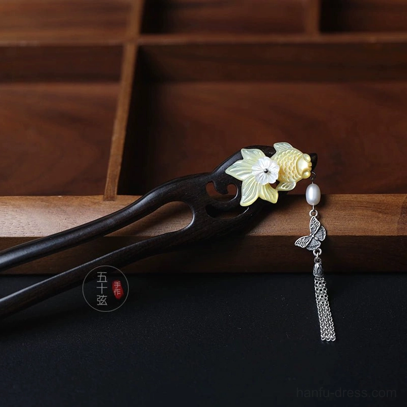 Golden Scales Chinese hair stick displayed on wooden tray with yellow fish and white flower decoration for traditional Hanfu updos