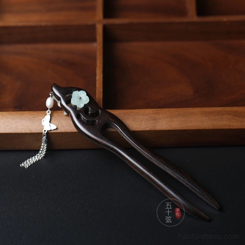 Dark double-pronged Chinese hair stick with light green flower ornament, bead and butterfly tassel in an elegant Hanfu accessory design