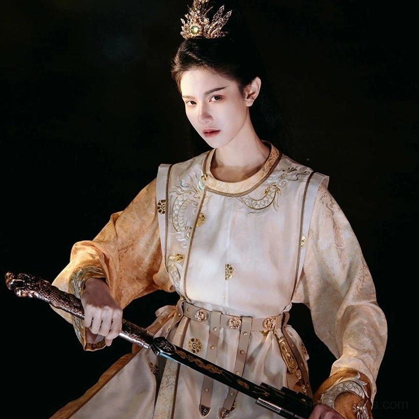 Front view of golden Tang dynasty hanfu robe for men and women with dragon-inspired chest embroidery, gold trim, round neck, adjustable waist belt, and antique sword