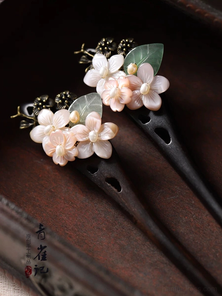 Pair of matching floral Chinese hair sticks with shell flower clusters green leaves bronze ornaments and dark hollow carved wood pins