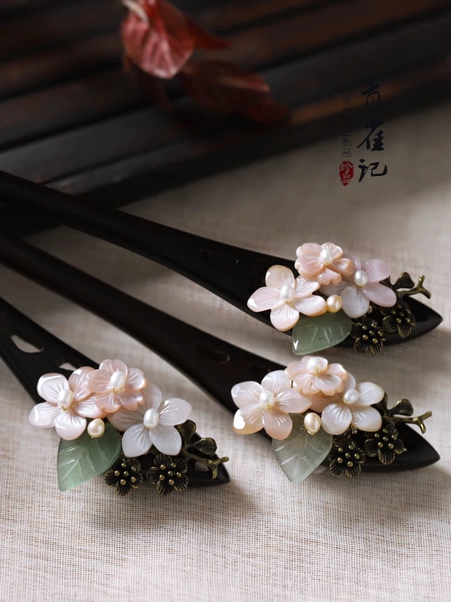 Three traditional Chinese flower hair sticks for Hanfu with pink blossom clusters jade-like green leaves and antique bronze decorations