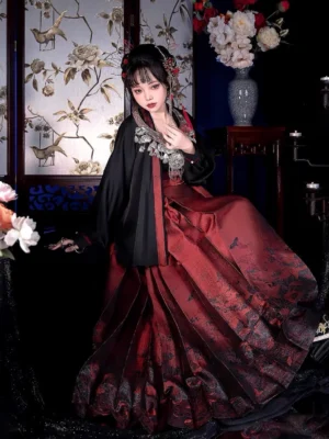Seated side view of modern Ming style Hanfu outfit with black Chinese style top, burgundy patterned mamianqun horse face skirt and traditional hair ornaments