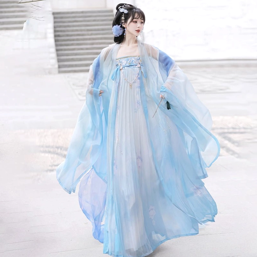 Gradient blue Tang Dynasty Qixiong Ruqun Hanfu front view with sheer wide sleeves, floral gown details, and matching blue hair decorations
